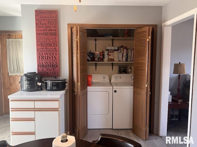 clothes washing area with independent washer and dryer