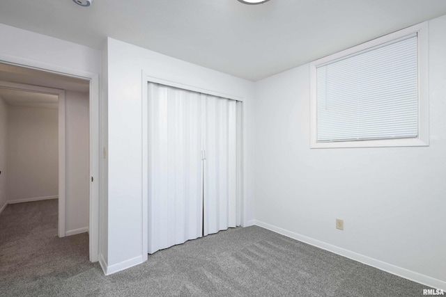 unfurnished bedroom featuring carpet and a closet