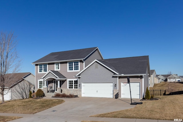 view of front of property with a garage and a front lawn