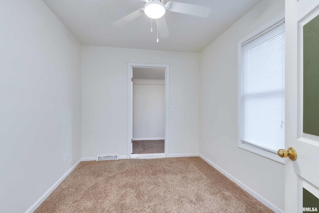 unfurnished bedroom featuring a closet, ceiling fan, and carpet flooring