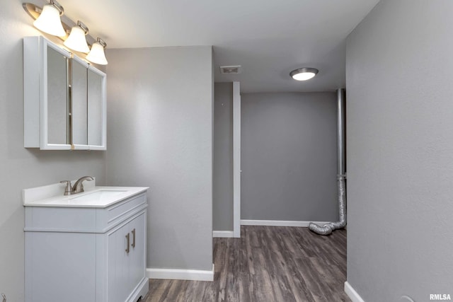 bathroom with hardwood / wood-style flooring and vanity