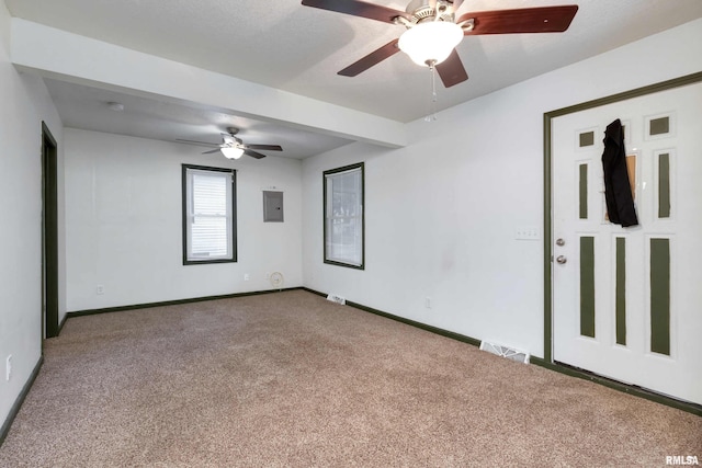 unfurnished room with ceiling fan, electric panel, and carpet floors