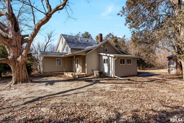 rear view of property featuring central AC unit