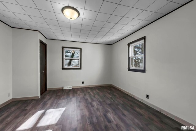 spare room featuring dark wood-type flooring