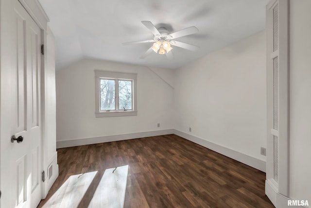 additional living space featuring vaulted ceiling, dark wood-type flooring, and ceiling fan