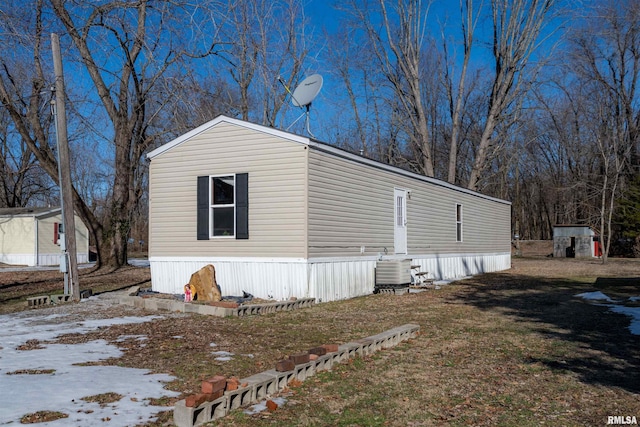 view of side of home featuring central air condition unit