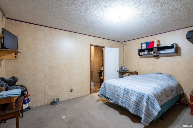 bedroom featuring light carpet and a textured ceiling