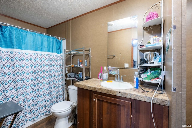 bathroom featuring wood-type flooring, vanity, ornamental molding, toilet, and a textured ceiling