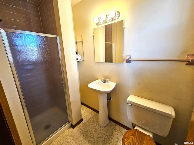 bathroom featuring toilet and walk in shower