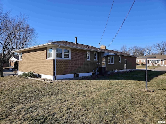 rear view of property with a yard and cooling unit