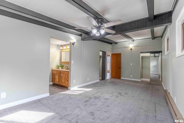 unfurnished bedroom with baseboard heating, a closet, dark carpet, and a textured ceiling