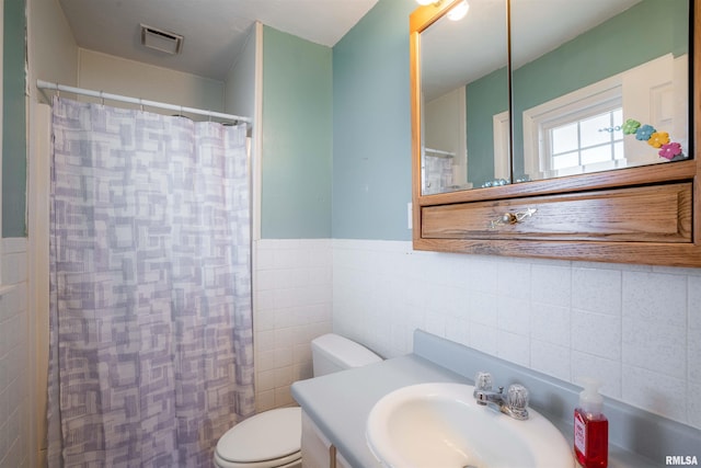 full bathroom featuring toilet, tile walls, visible vents, and vanity