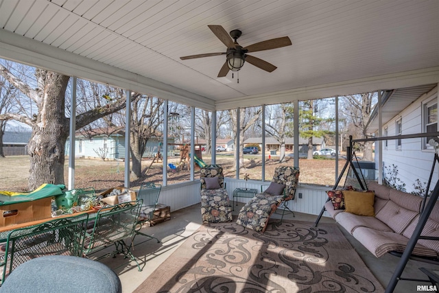 sunroom featuring an outdoor hangout area, a ceiling fan, and a healthy amount of sunlight