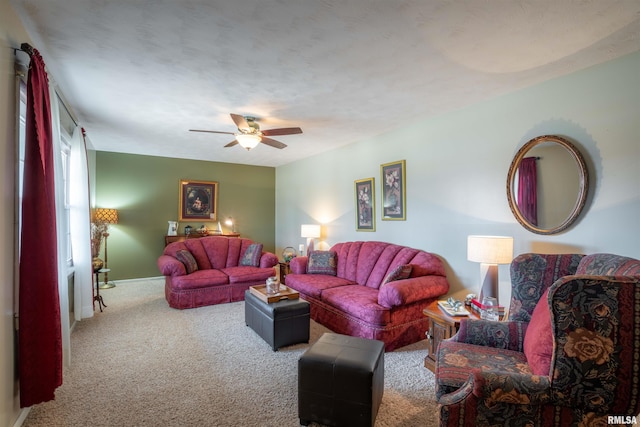carpeted living area featuring a ceiling fan and baseboards