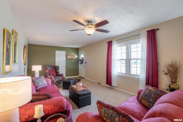 carpeted living room featuring a ceiling fan and baseboards