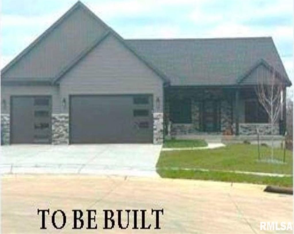 view of front of home with a garage and a front lawn