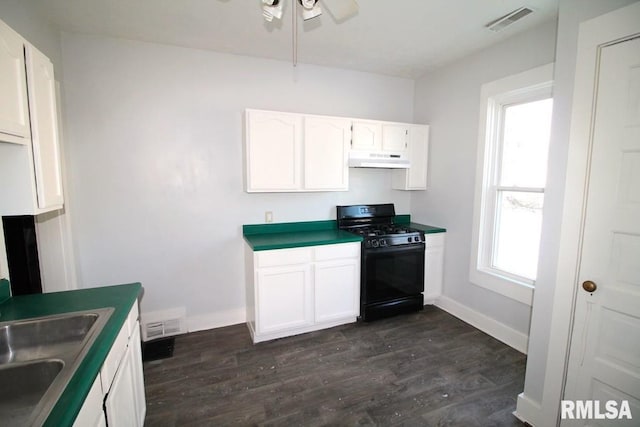 kitchen with plenty of natural light, black range with gas stovetop, sink, and white cabinets