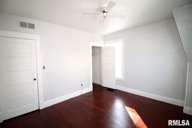 unfurnished bedroom with a closet, dark hardwood / wood-style floors, and ceiling fan