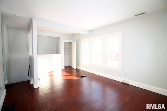 spare room featuring dark wood-type flooring