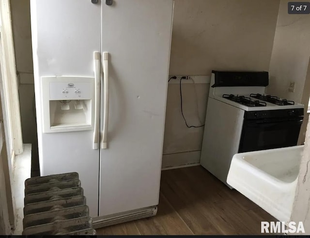 kitchen with dark wood-type flooring and white appliances