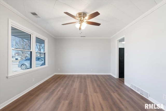 spare room featuring baseboards, visible vents, dark wood finished floors, ceiling fan, and ornamental molding