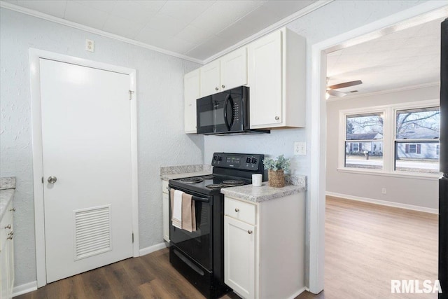 kitchen with visible vents, white cabinets, black appliances, dark wood finished floors, and crown molding