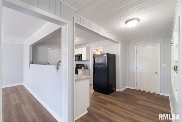 kitchen featuring dark wood-style floors, light countertops, crown molding, black appliances, and white cabinetry