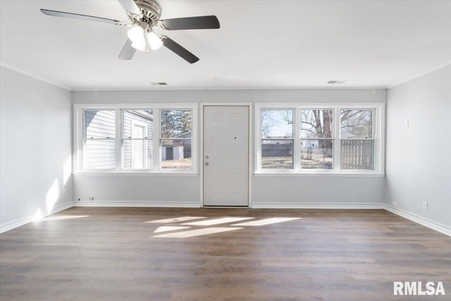 unfurnished living room with wood finished floors, visible vents, and a healthy amount of sunlight