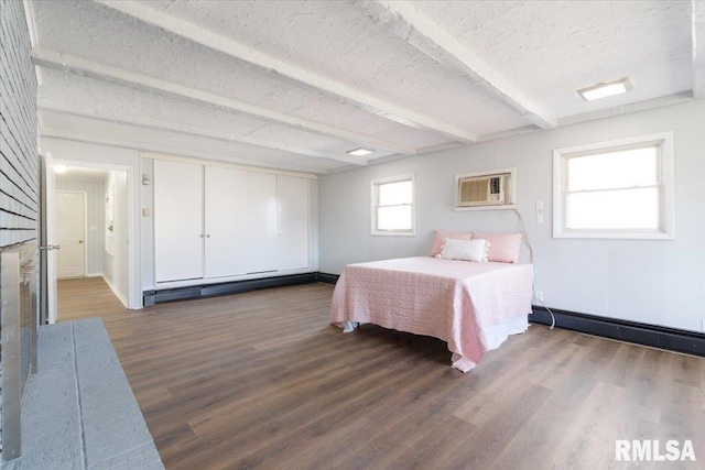 bedroom with a textured ceiling, beamed ceiling, dark wood-style flooring, and a baseboard radiator