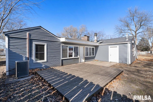 back of house featuring a chimney, central AC unit, and a deck