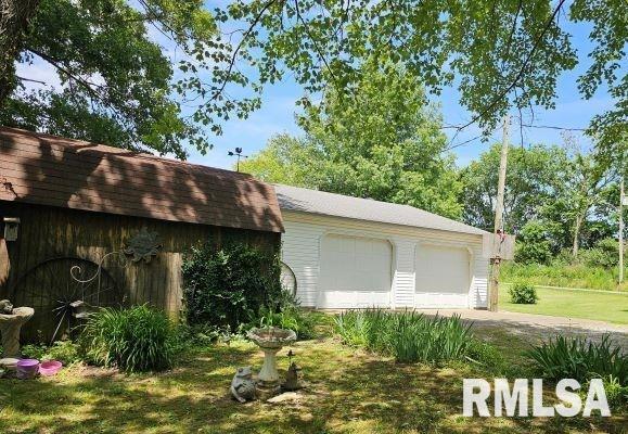 exterior space with an outbuilding and a garage