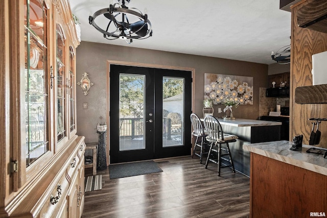 foyer with french doors and dark hardwood / wood-style floors