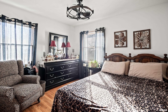 bedroom featuring wood-type flooring and multiple windows