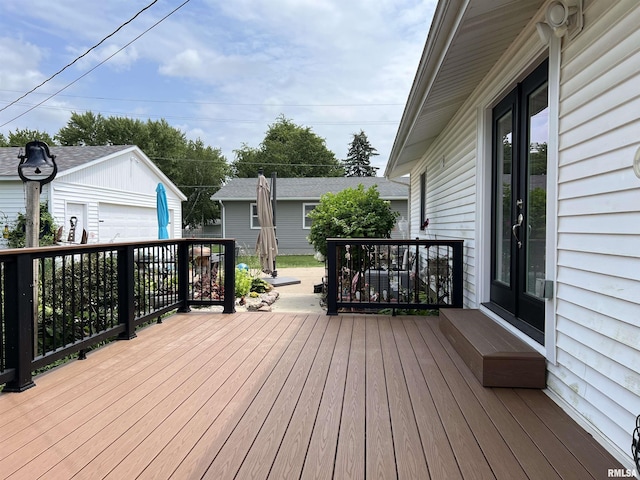 deck featuring a garage and an outbuilding