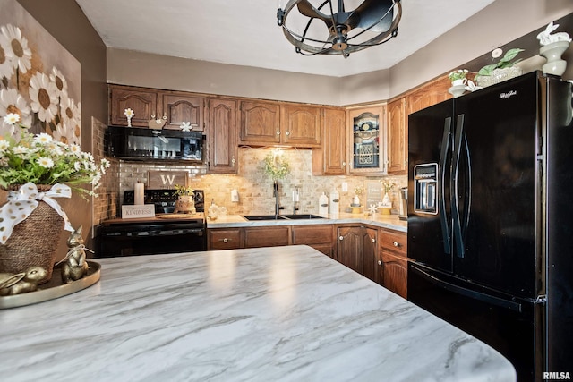 kitchen featuring ceiling fan, sink, decorative backsplash, and black appliances