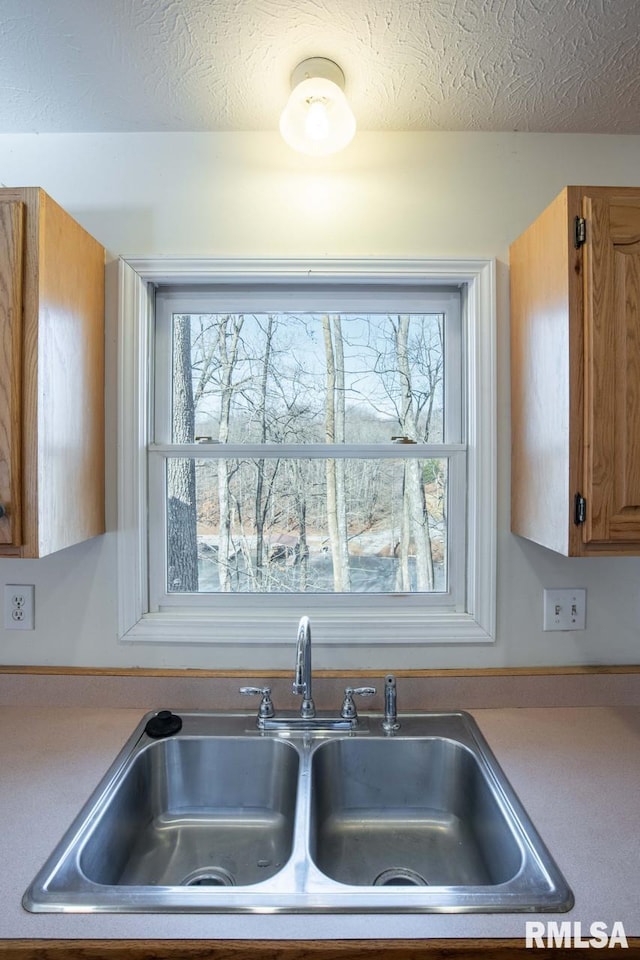 kitchen featuring sink and a textured ceiling