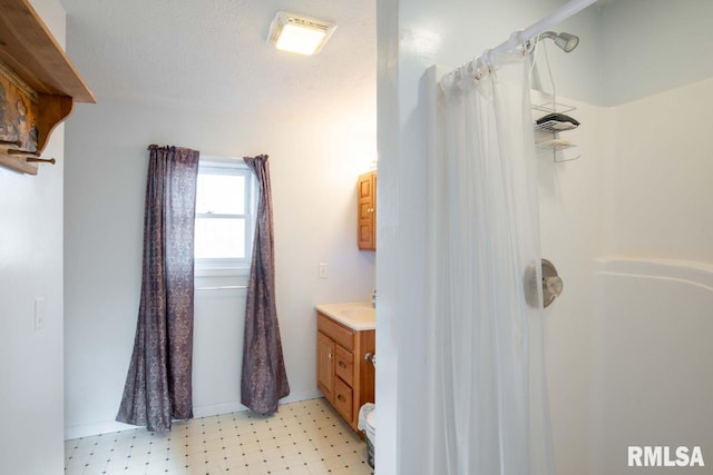 bathroom with vanity and a shower with shower curtain