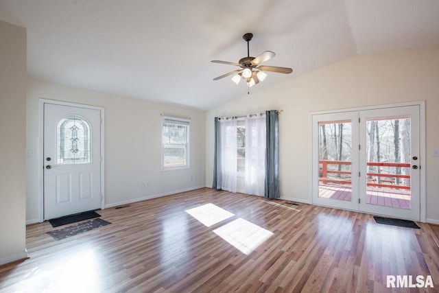 foyer with ceiling fan, light hardwood / wood-style flooring, a healthy amount of sunlight, and vaulted ceiling