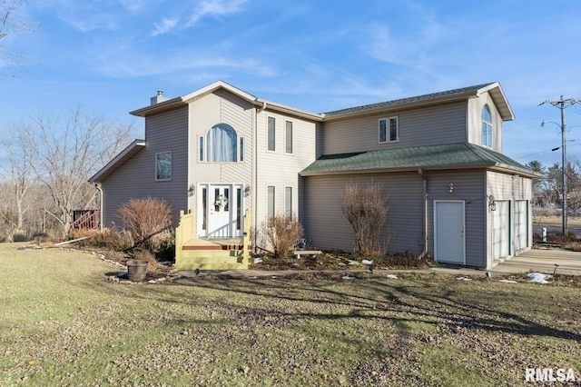 view of front of house with a garage and a front yard