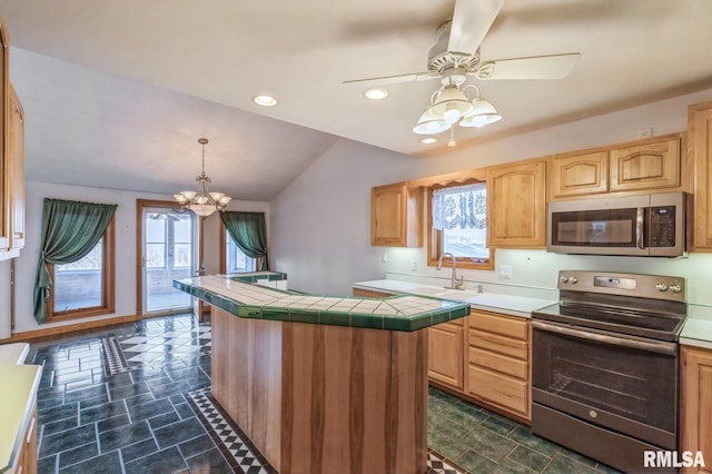 kitchen featuring sink, appliances with stainless steel finishes, light brown cabinetry, decorative light fixtures, and tile countertops