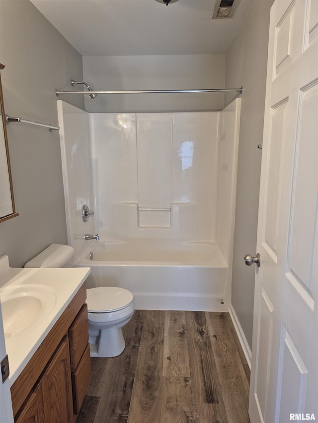 full bathroom with vanity, toilet,  shower combination, and hardwood / wood-style floors