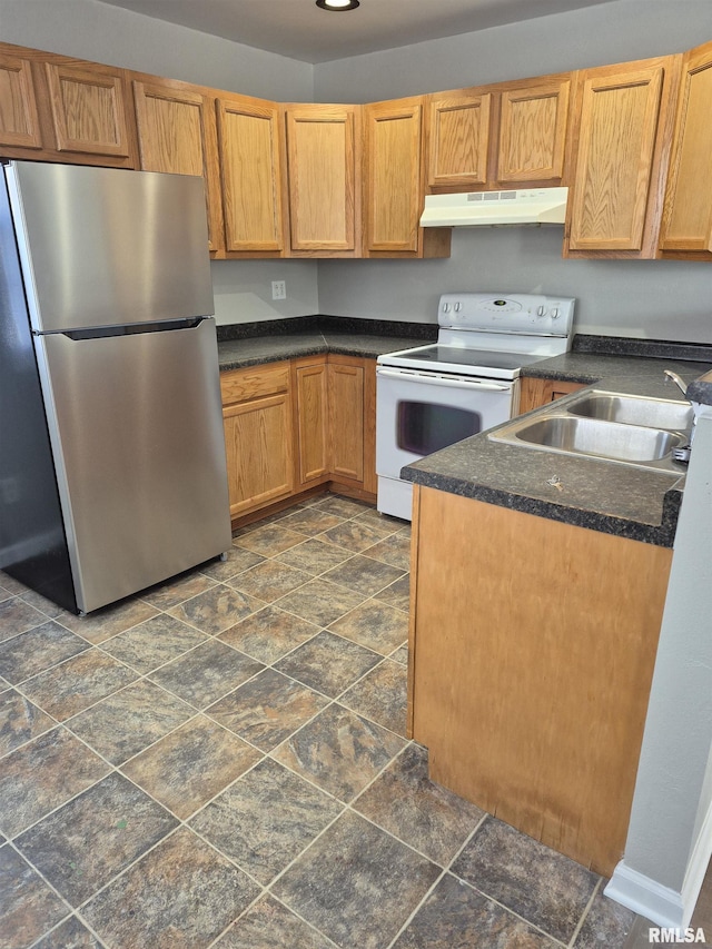 kitchen featuring stainless steel refrigerator, sink, and white range with electric stovetop