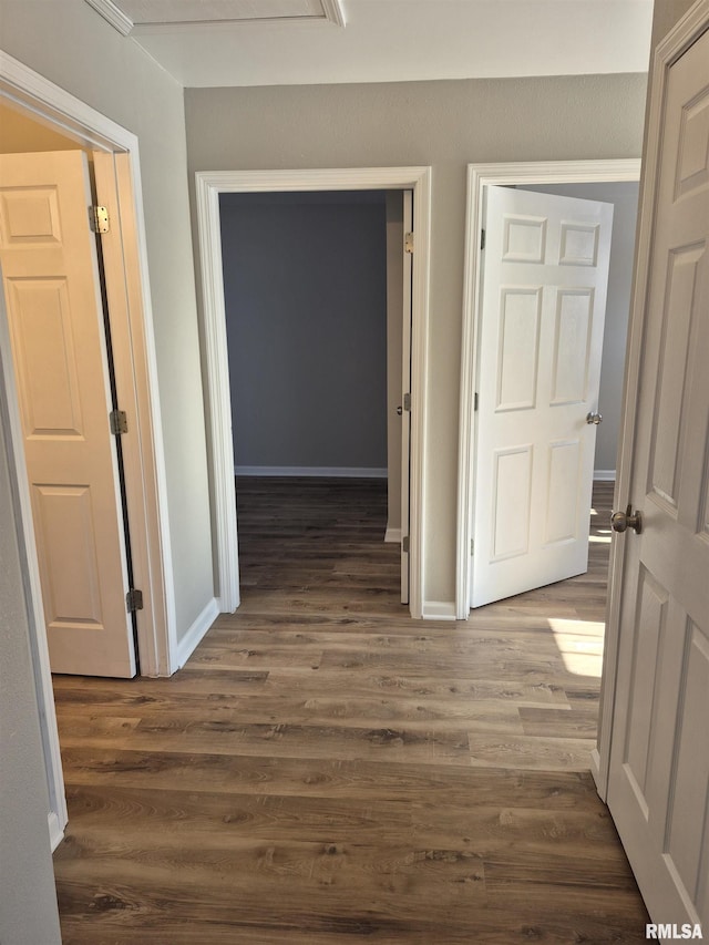 corridor featuring dark hardwood / wood-style flooring