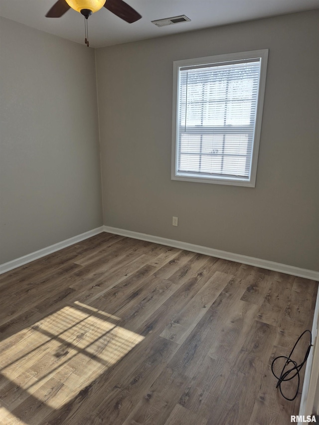 empty room featuring wood-type flooring and ceiling fan