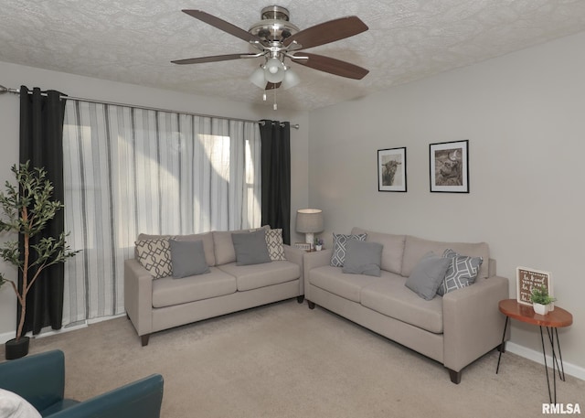 carpeted living room featuring ceiling fan and a textured ceiling