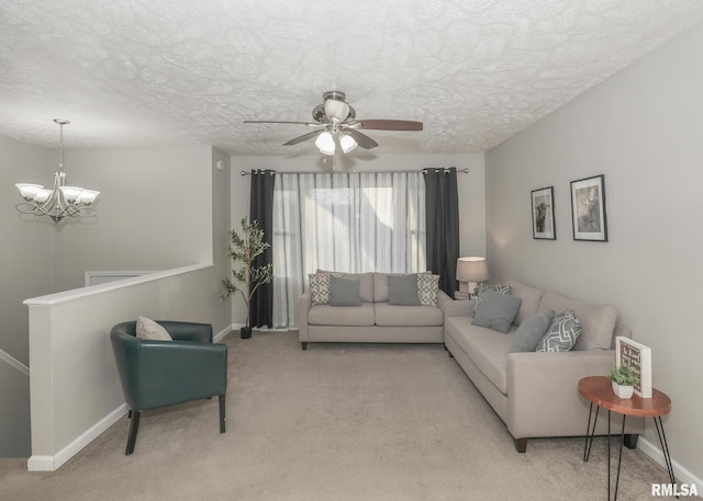 carpeted living room with ceiling fan with notable chandelier and a textured ceiling