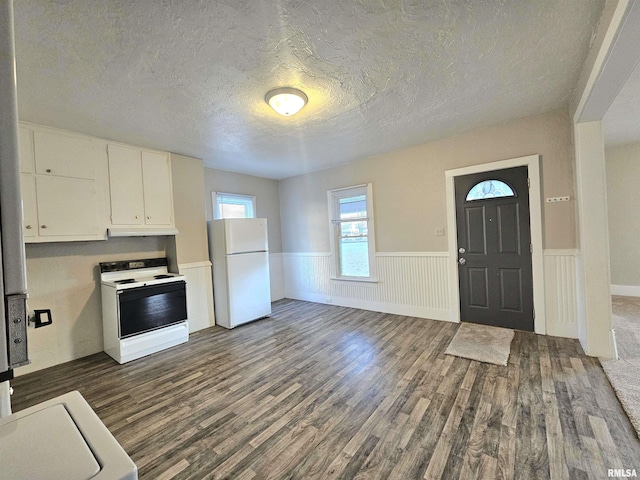 kitchen with white cabinetry, dark wood-type flooring, a textured ceiling, and white appliances