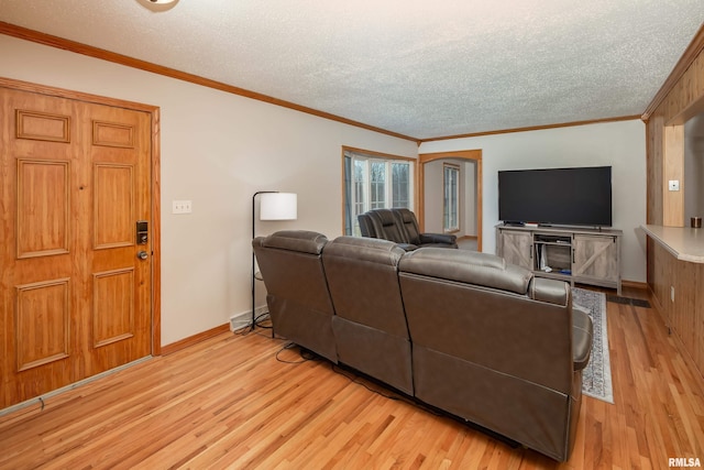 living room with crown molding, a textured ceiling, and light wood-type flooring