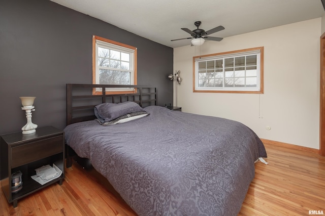 bedroom with ceiling fan and light hardwood / wood-style floors