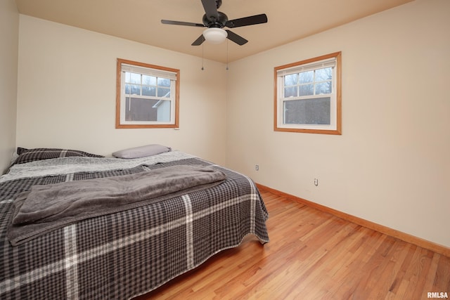 bedroom featuring light hardwood / wood-style floors and ceiling fan